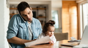 Man on phone with young daughter